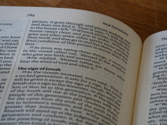An open book on a table with a cell phone