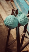 A ball of yarn sitting on top of a wooden chair