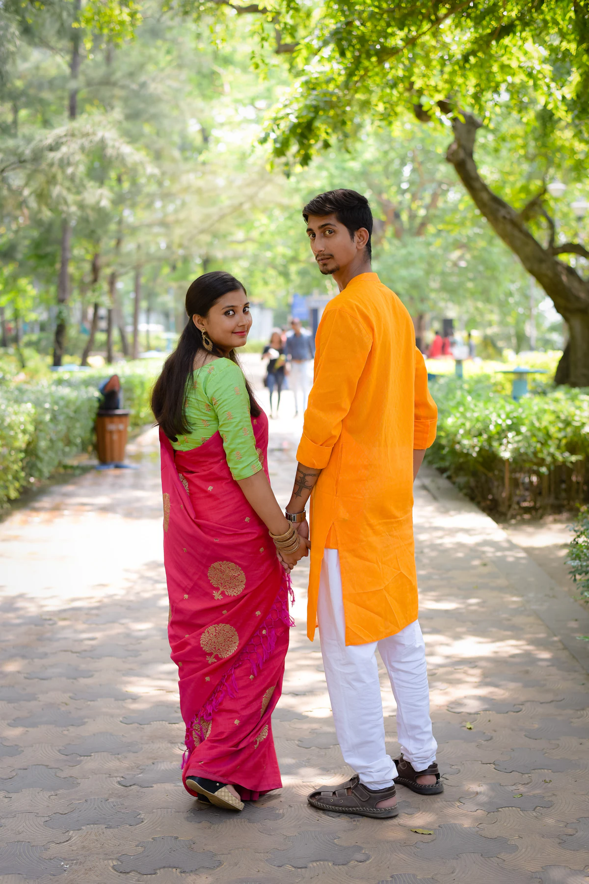 A young couple walking together in a park
