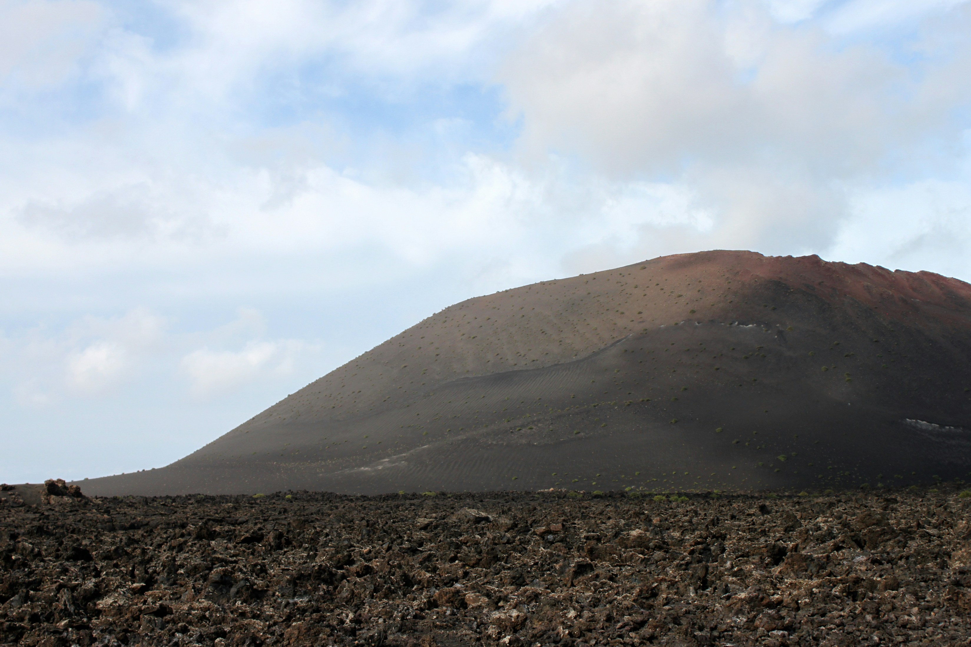 A large mountain with a sky background