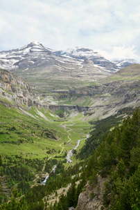 A view of a valley with mountains in the background