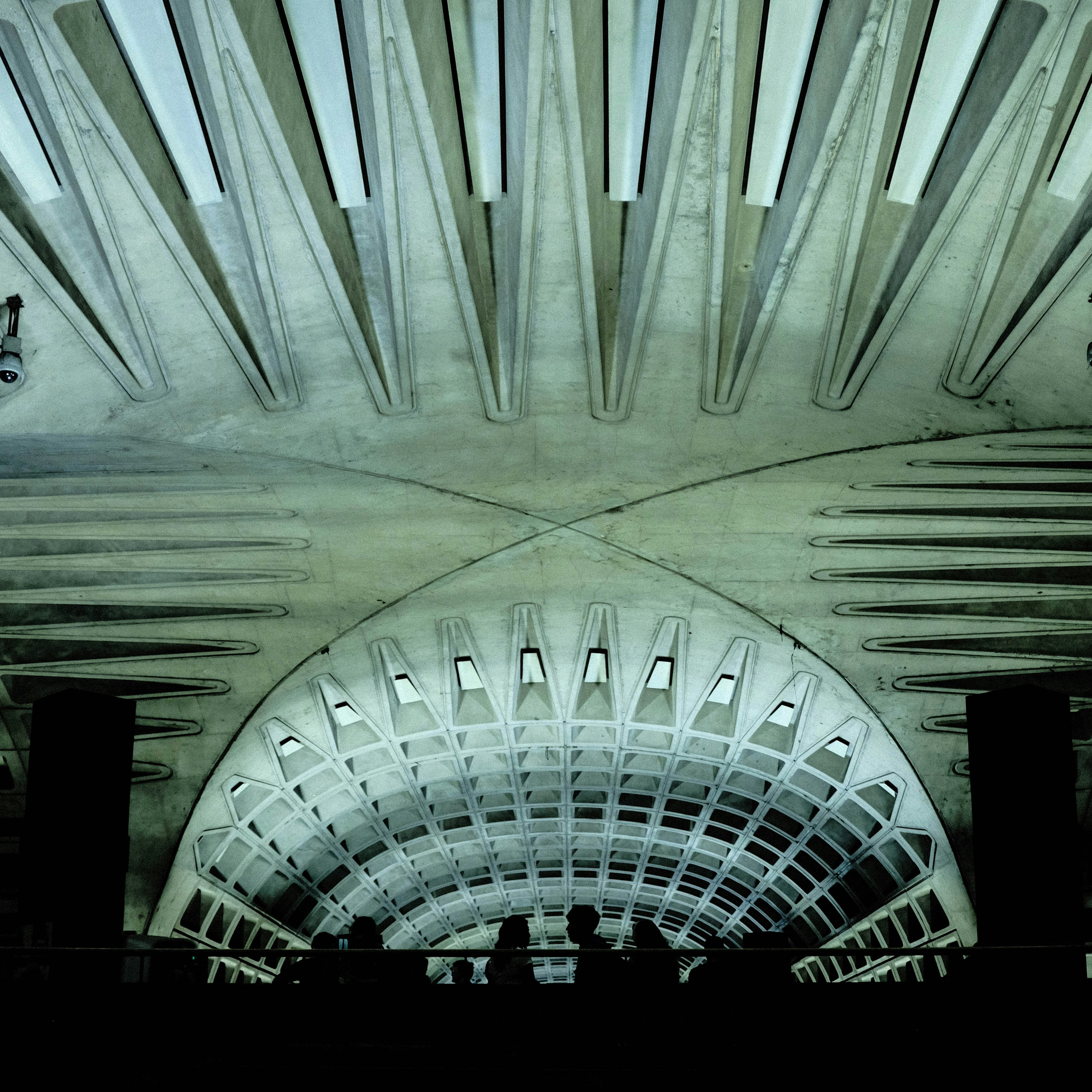 The ceiling of a building with a clock on it