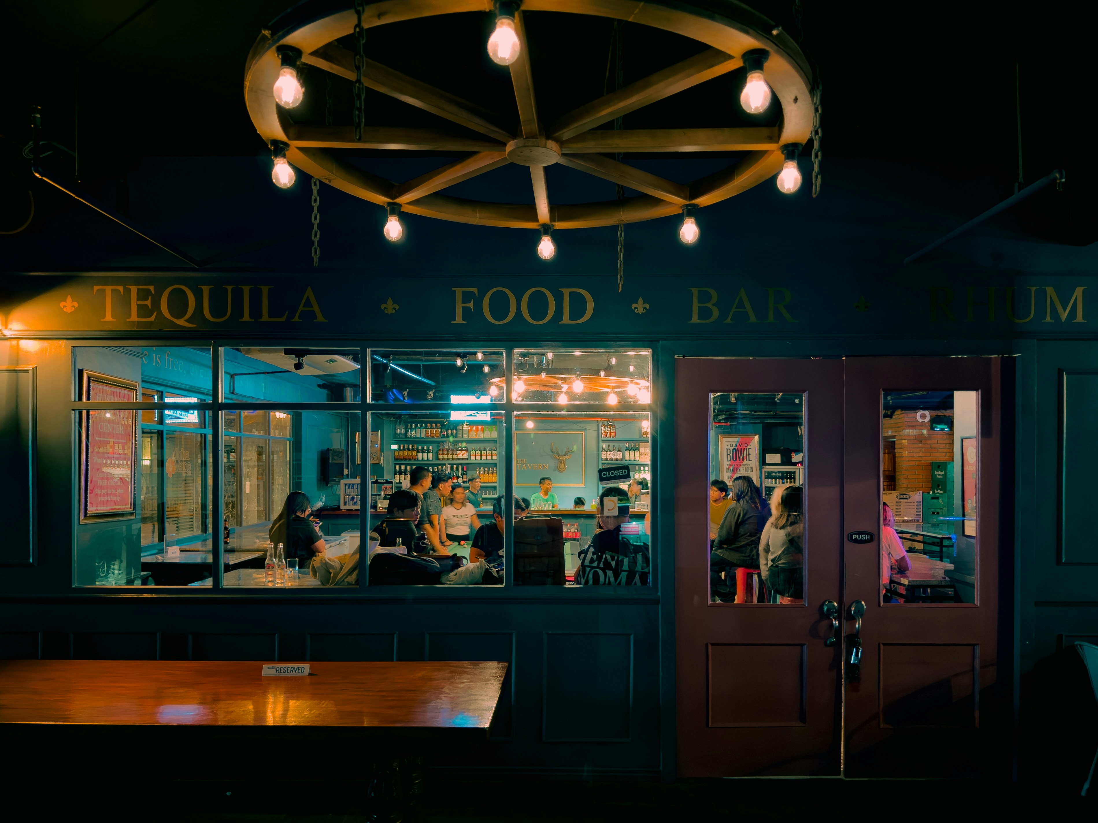 A group of people sitting at a table in front of a restaurant
