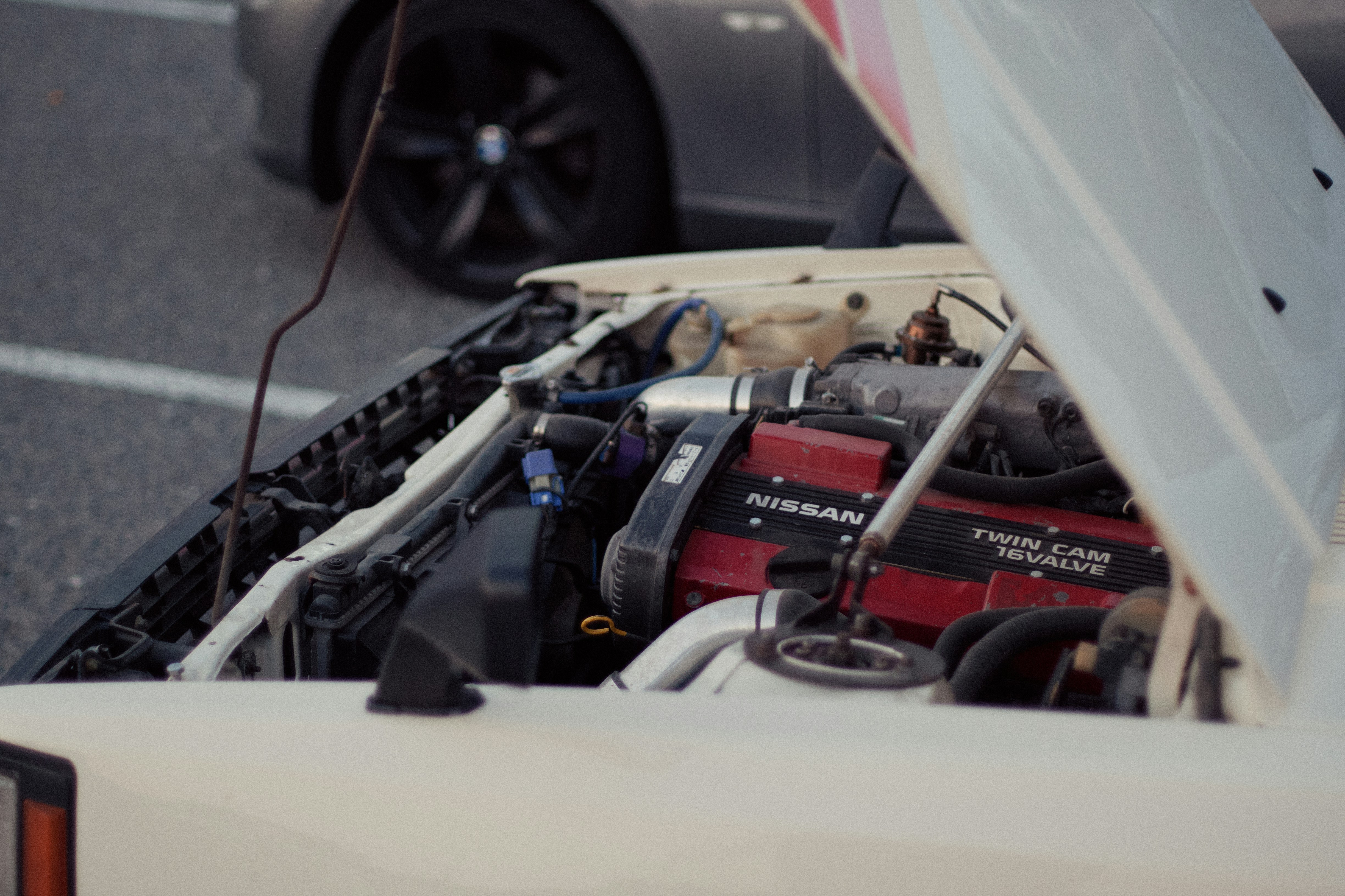Technician checking the high-voltage battery area of a used electric car