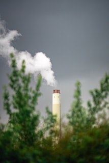 A smokestack emits from a factory chimney