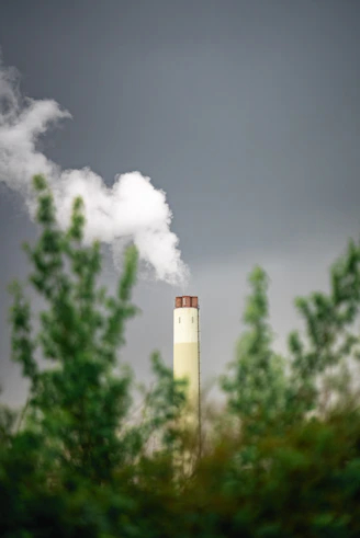 A smokestack emits from a factory chimney