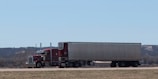 A large semi truck driving down a highway