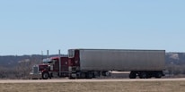 A large semi truck driving down a highway