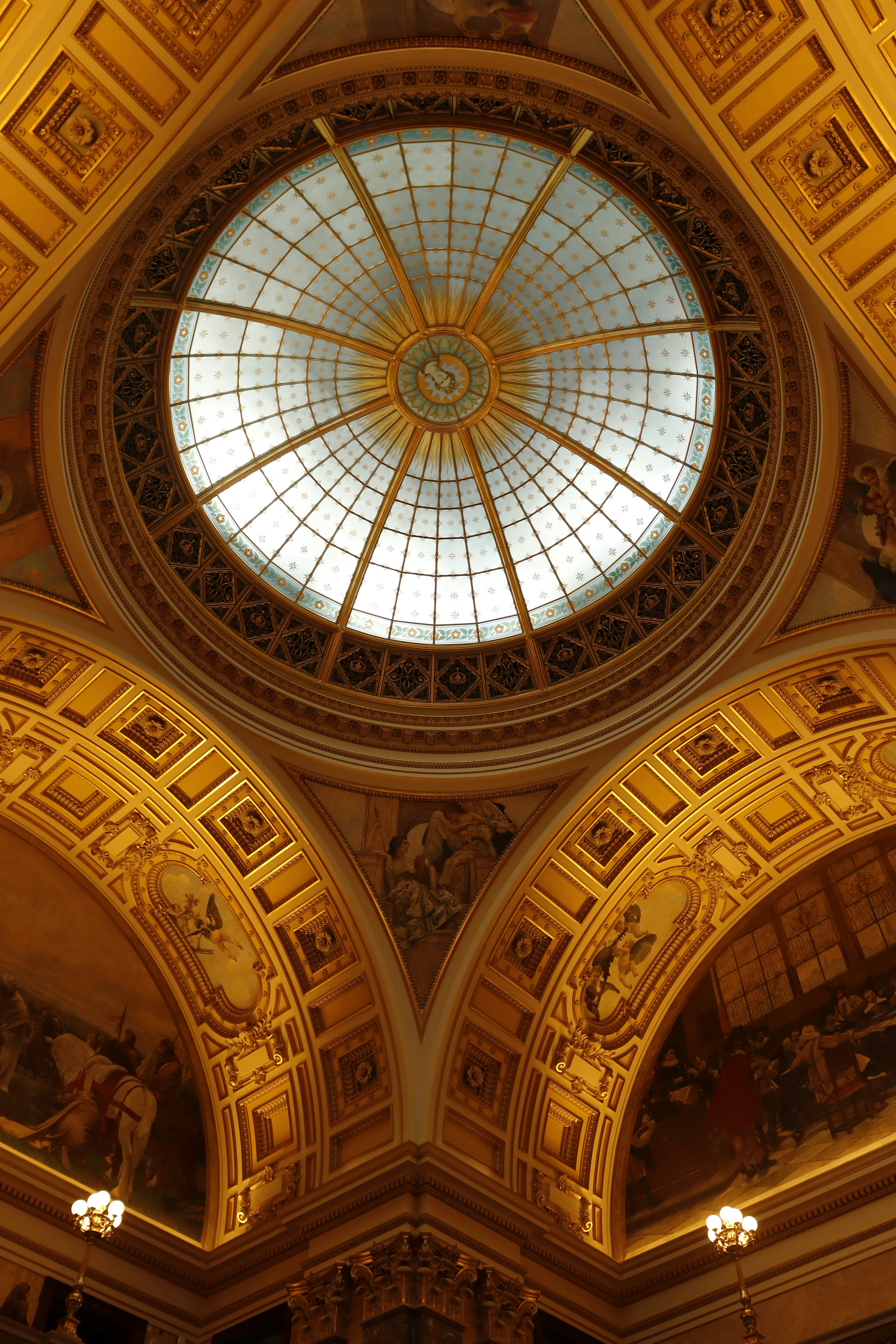 A ceiling with a glass dome in a building