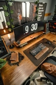 A wooden desk topped with a computer monitor and keyboard