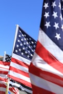 A group of american flags blowing in the wind