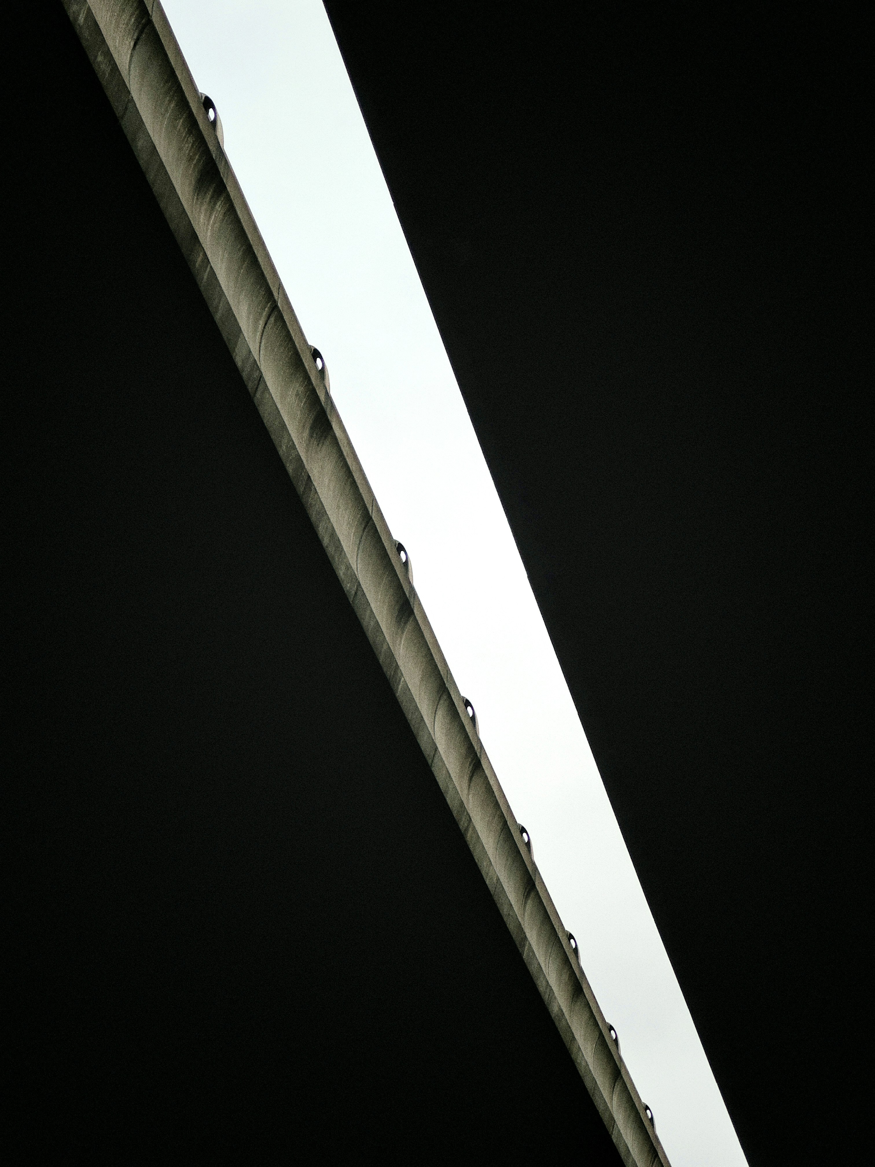 A tall bridge with a traffic light on top of it