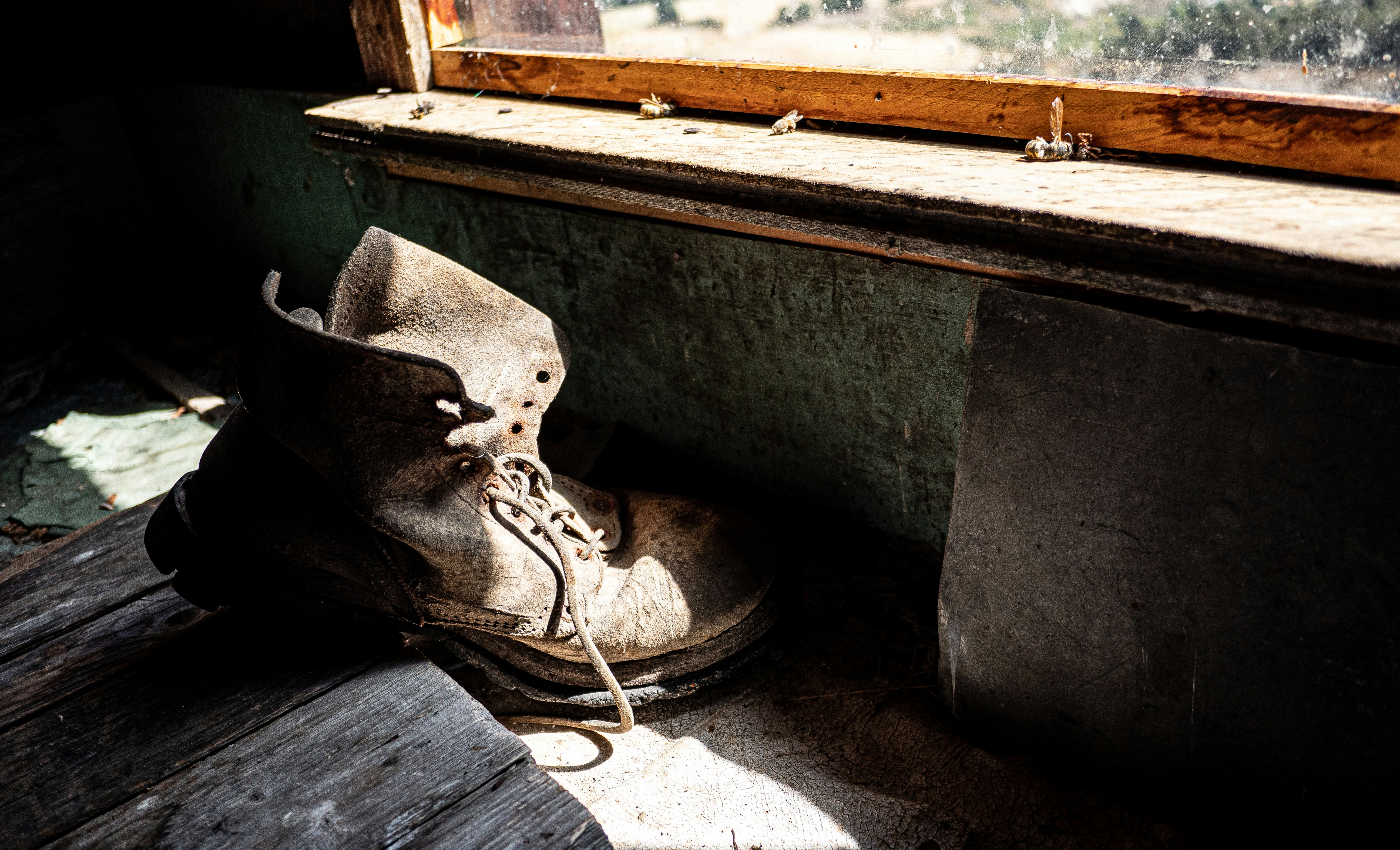 A pair of shoes sitting on top of a wooden bench