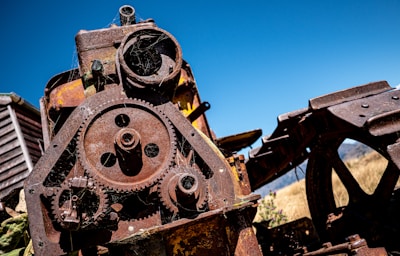An old rusty train engine sitting on top of a pile of junk