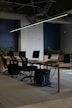 An empty office with a long table and chairs