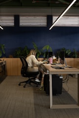 A woman sitting at a desk in an office