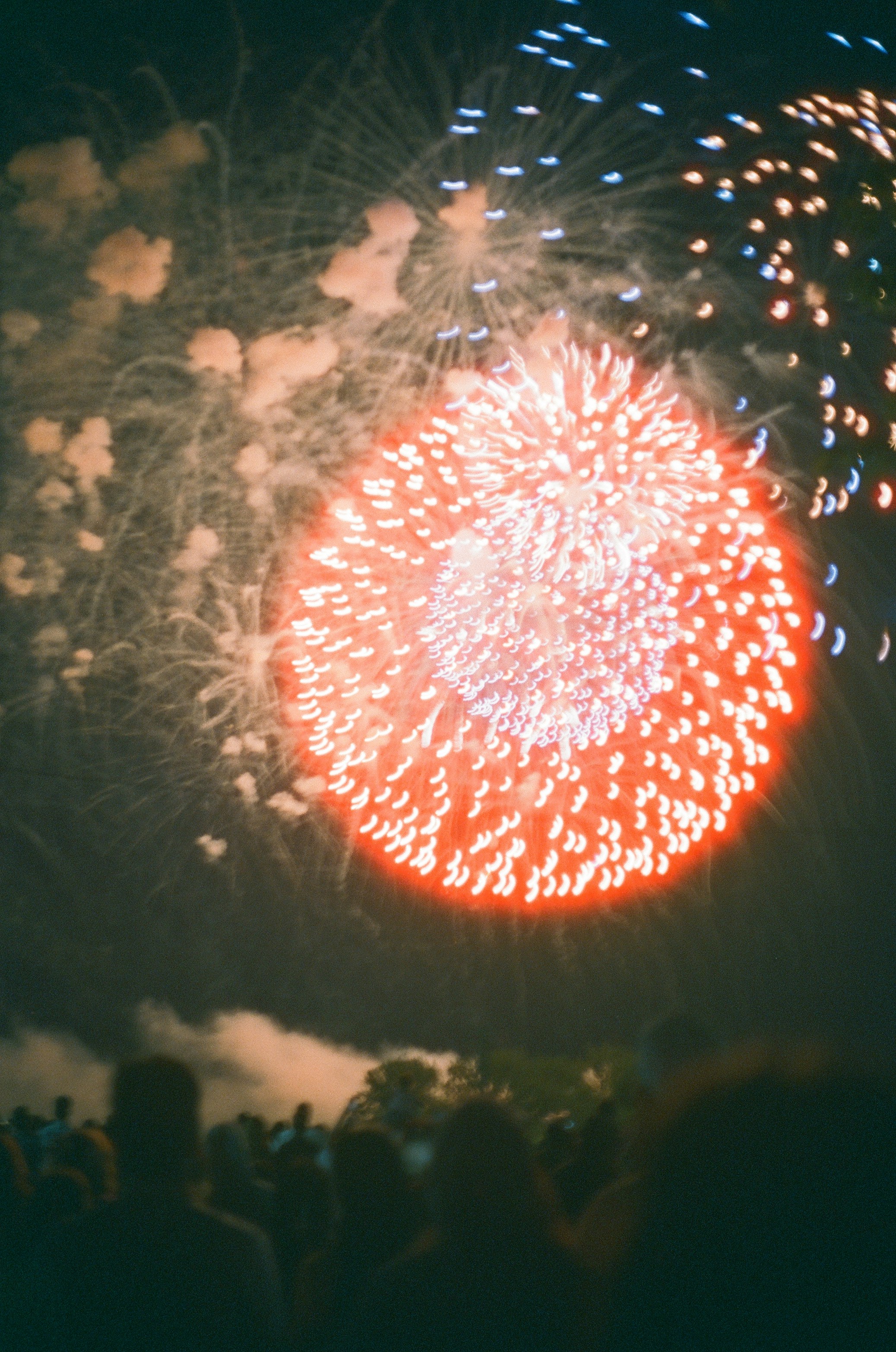 A crowd of people watching a fireworks display