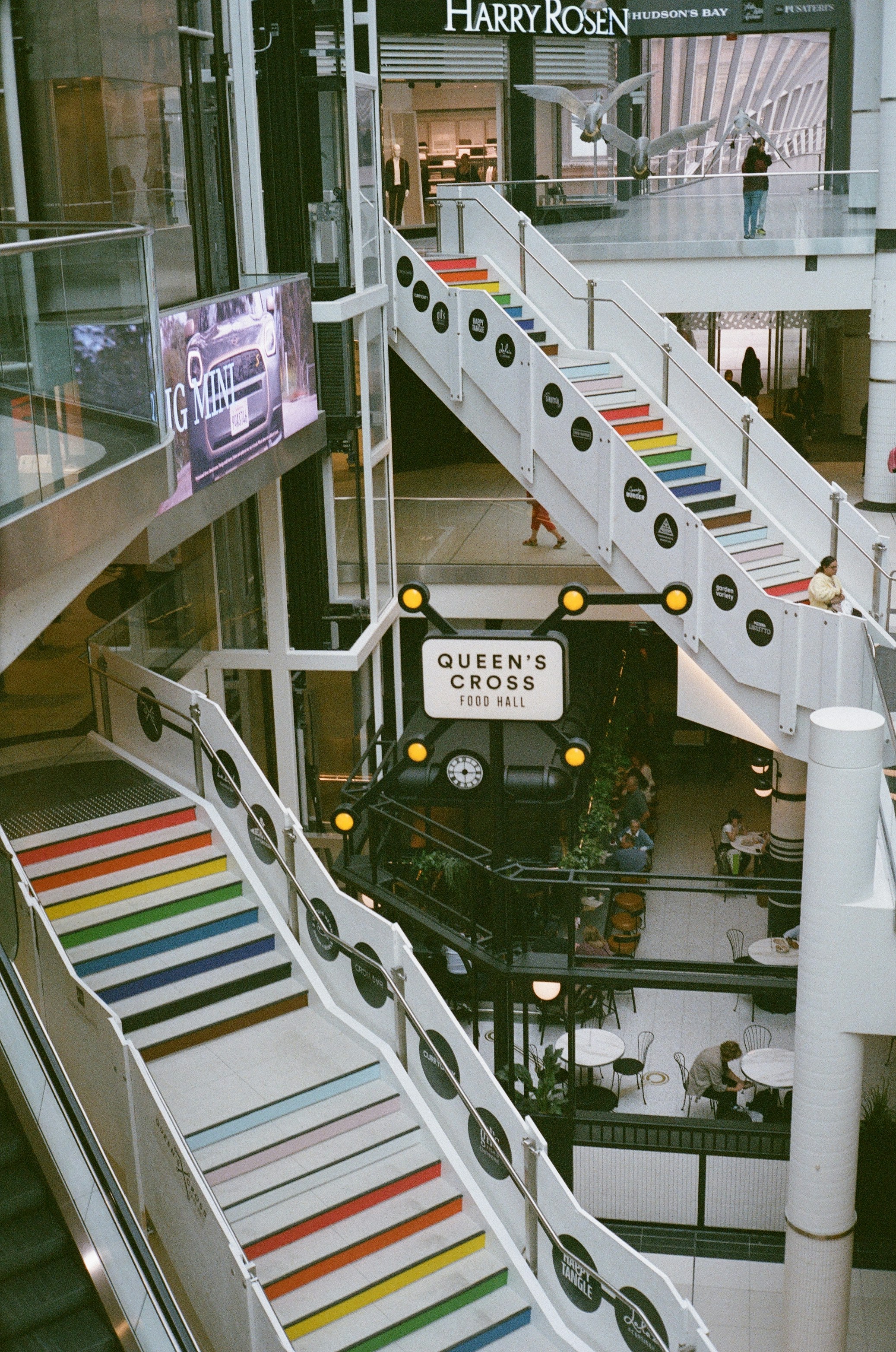 An escalator in a large building with stairs