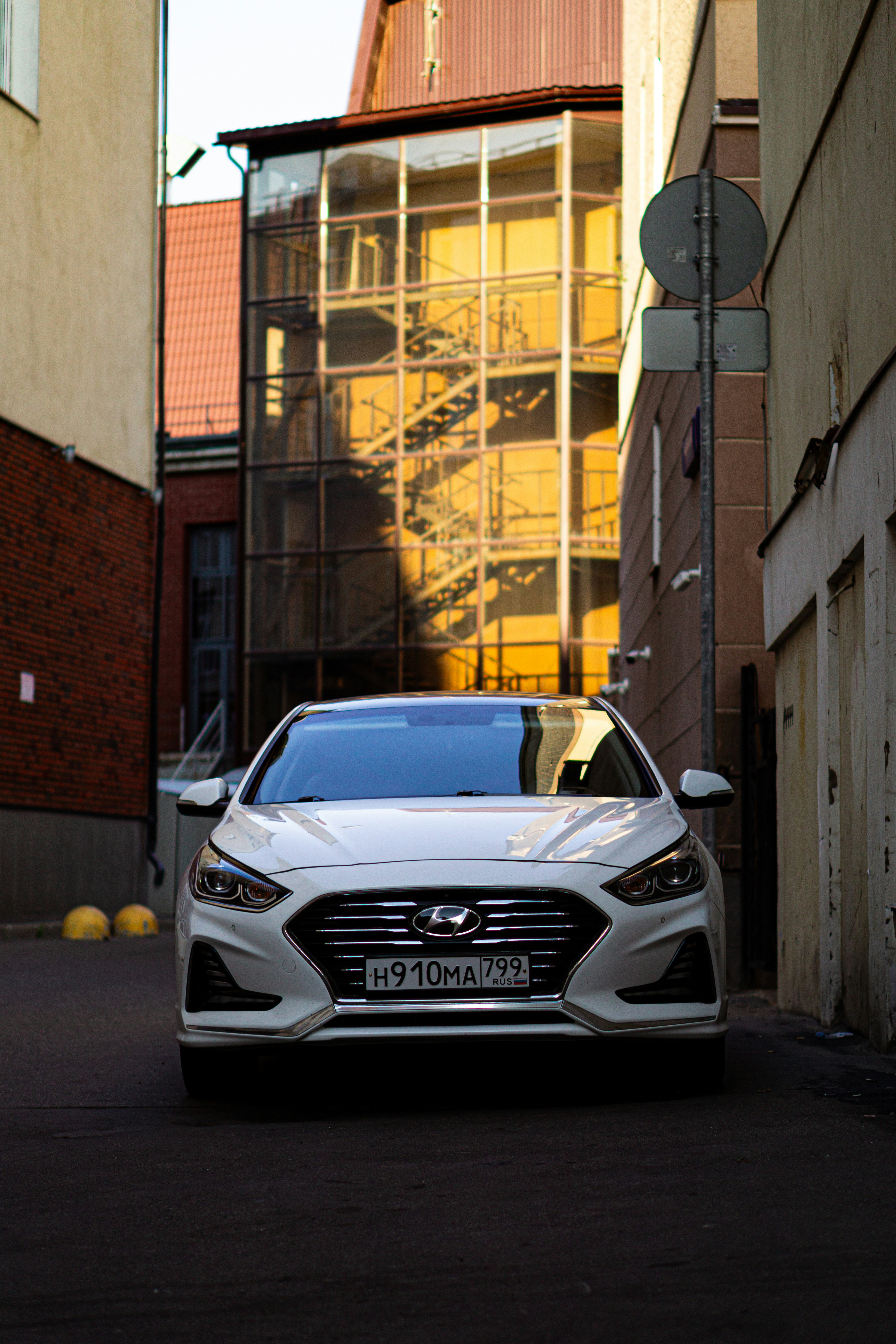 White Hyundai Sonata sedan parked on a clean street