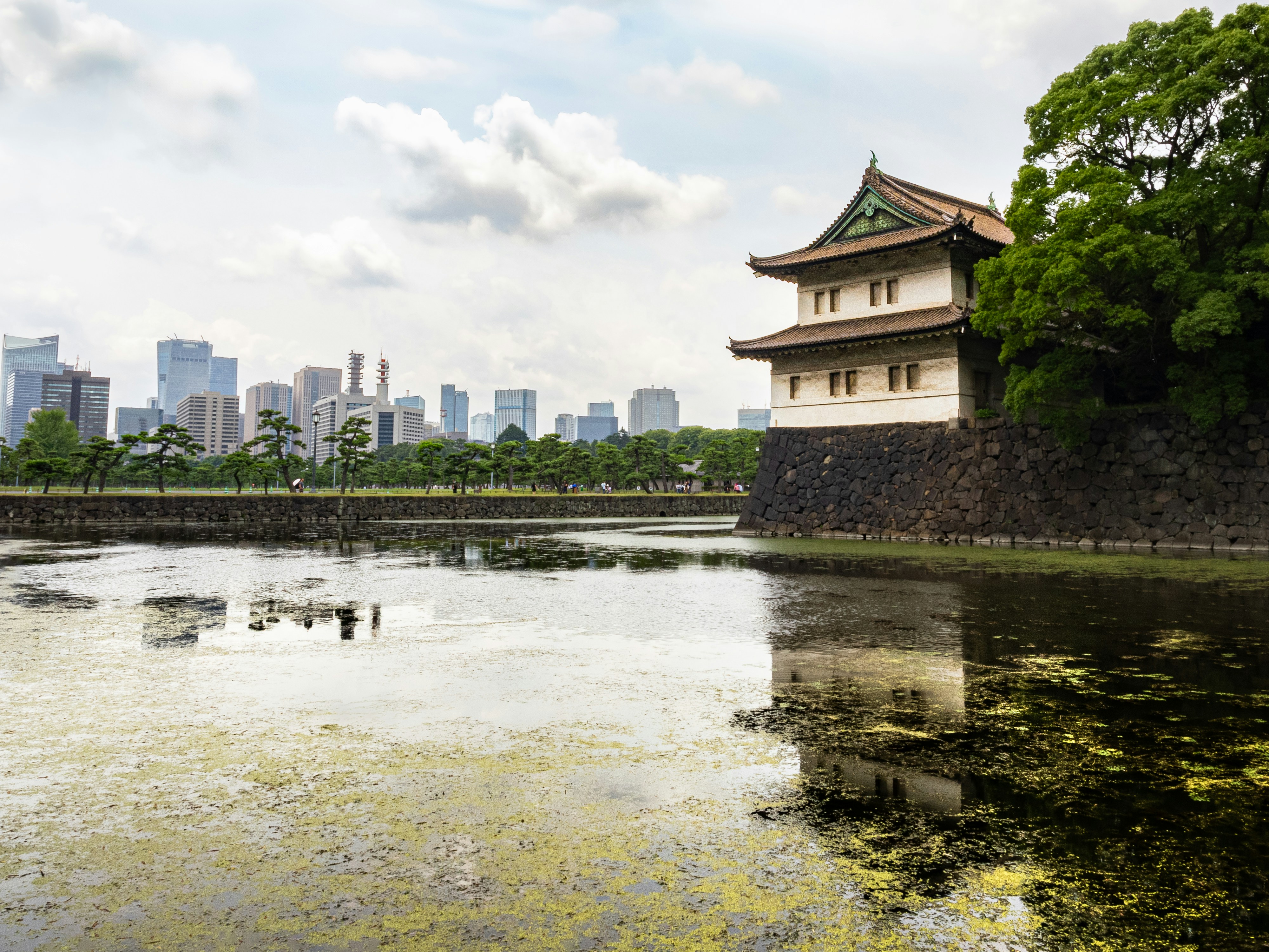 A large body of water with a building in the background, Imperial Palace, Tokyo, Japan.