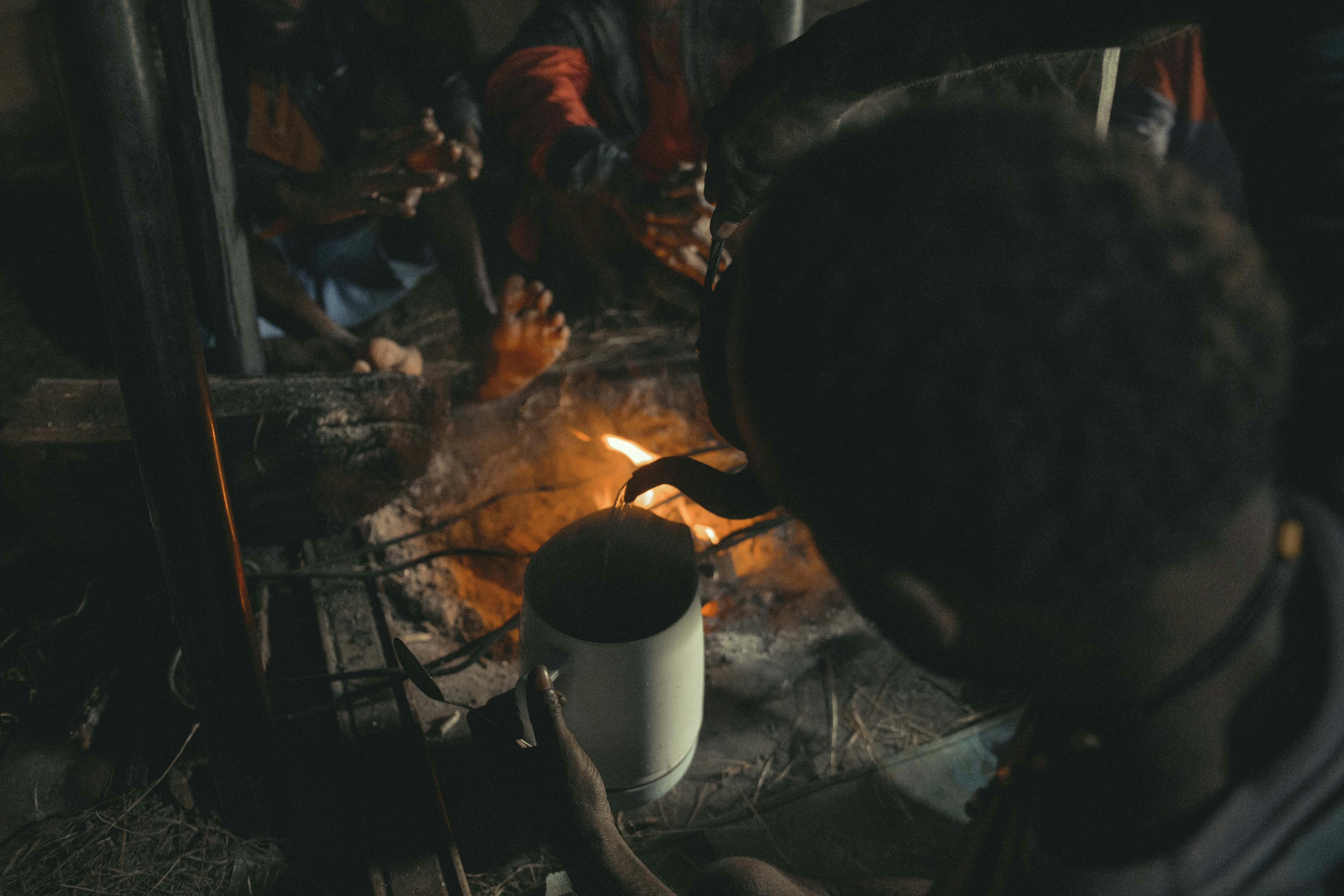 A dwarven blacksmith hammering a glowing piece of metal on an anvil.