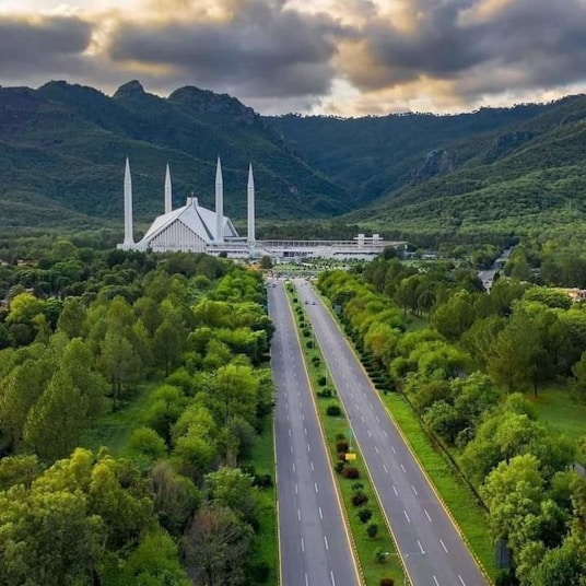 An aerial view of a large building in the middle of a forest