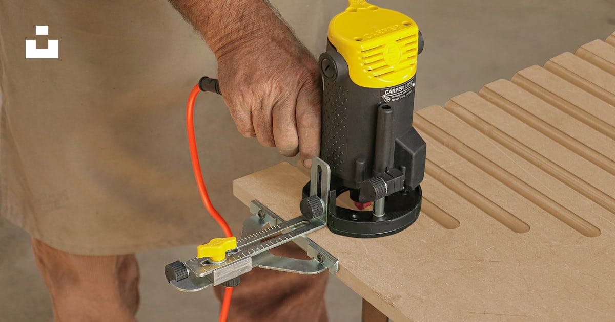 A man using a router to cut a piece of wood photo β Free India Image on ...