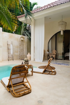 A pool with a chair and a table next to it