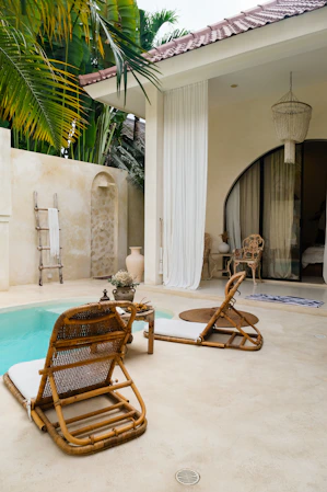 A pool with a chair and a table next to it