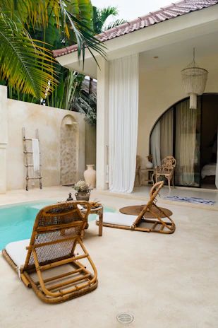 A pool with a chair and a table next to it