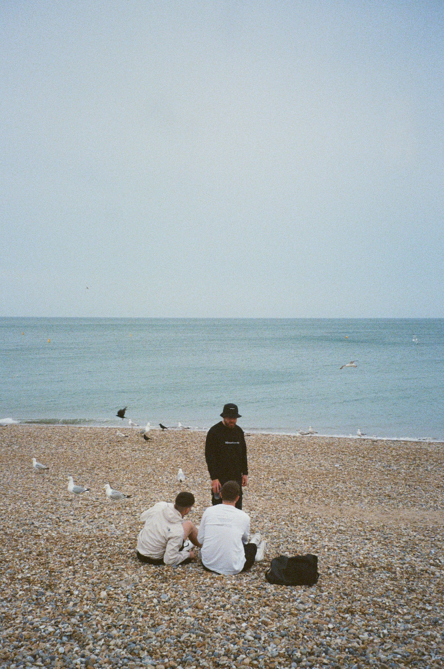 A group of people sitting on top of a beach