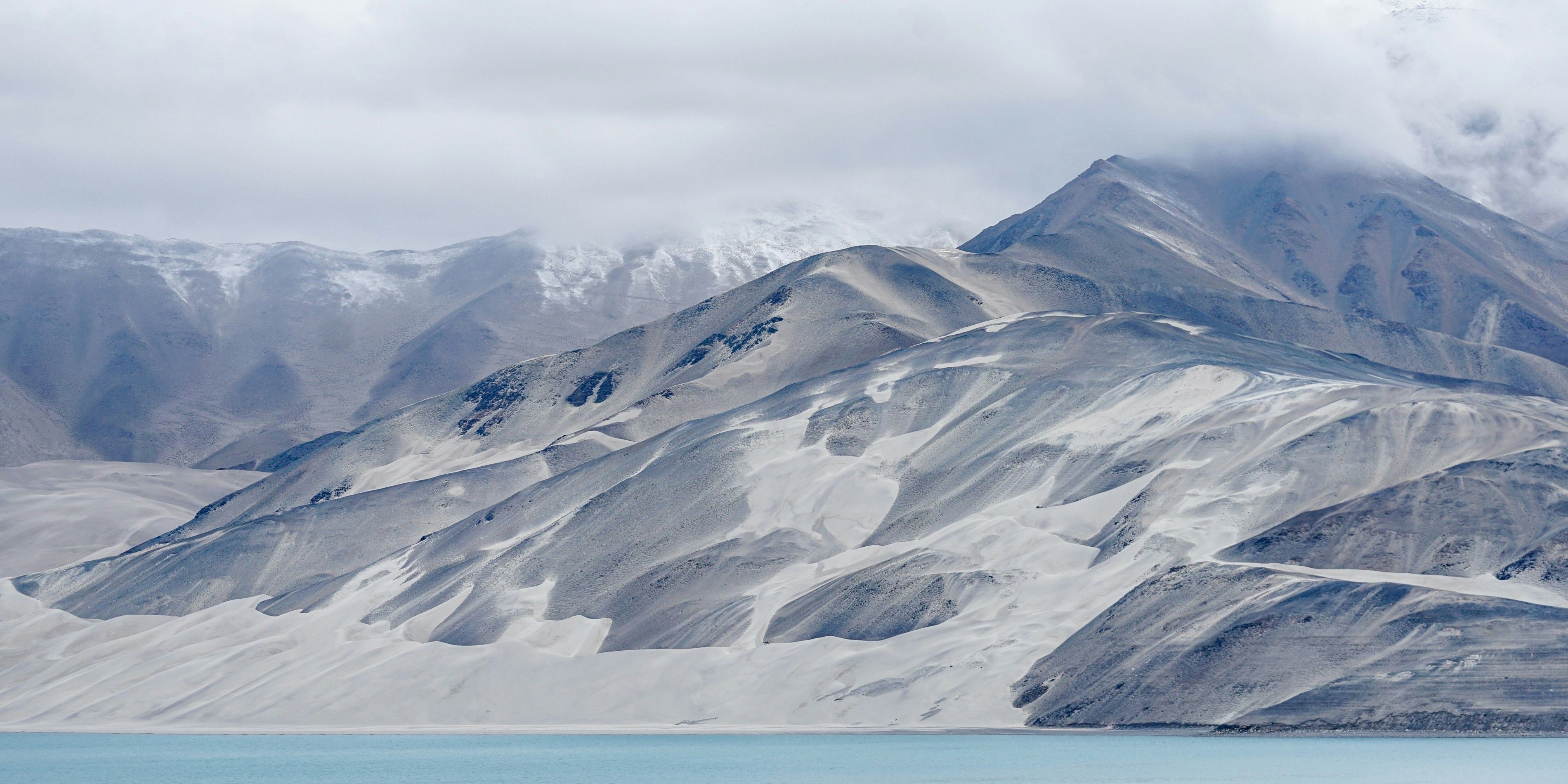 A large body of water surrounded by mountains