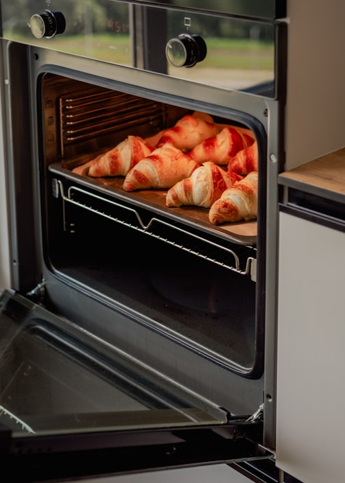A close up of food cooking in an oven