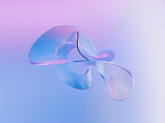 A blurry image of a flower on a blue and pink background