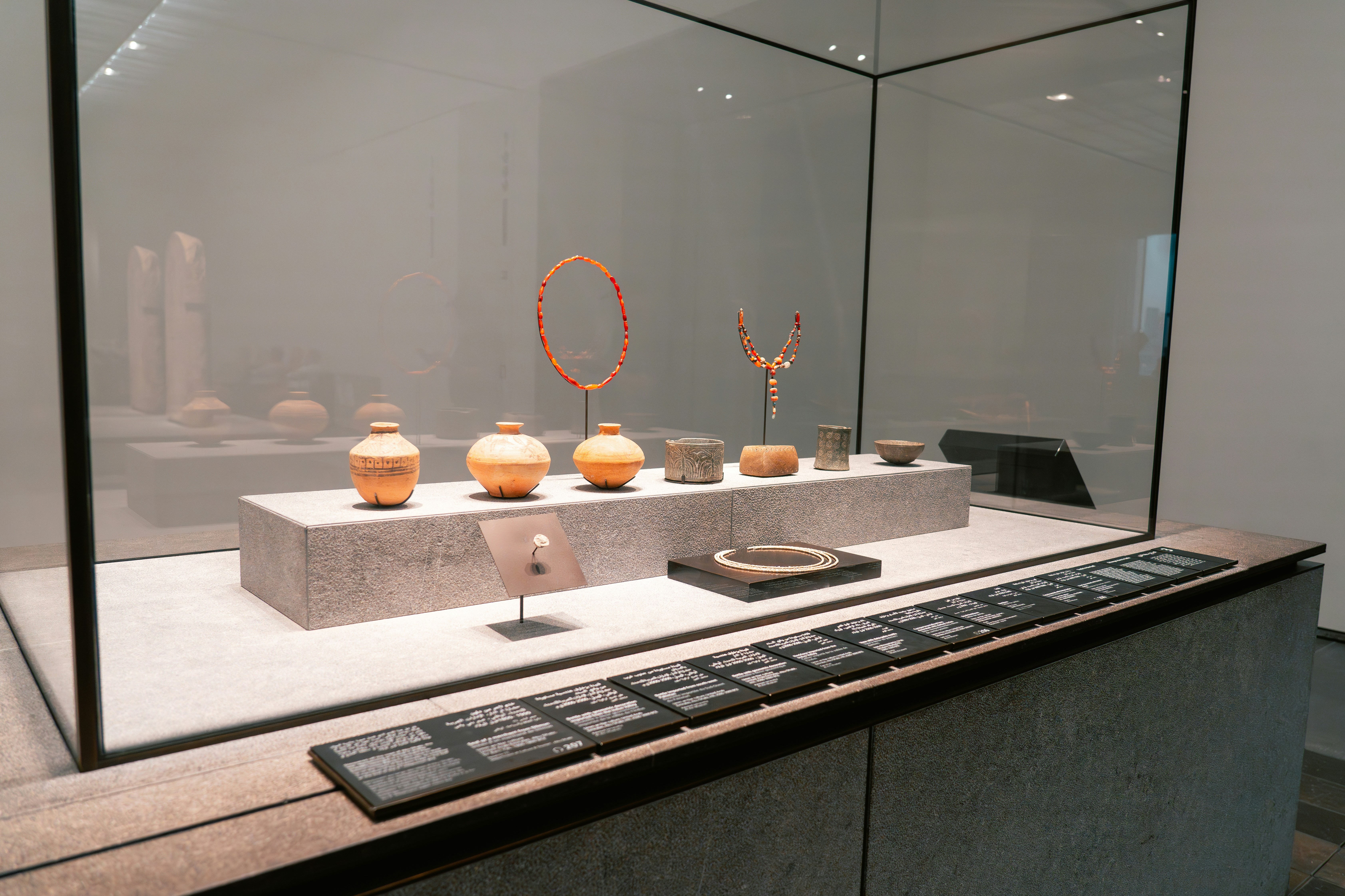 A display of vases in a glass case