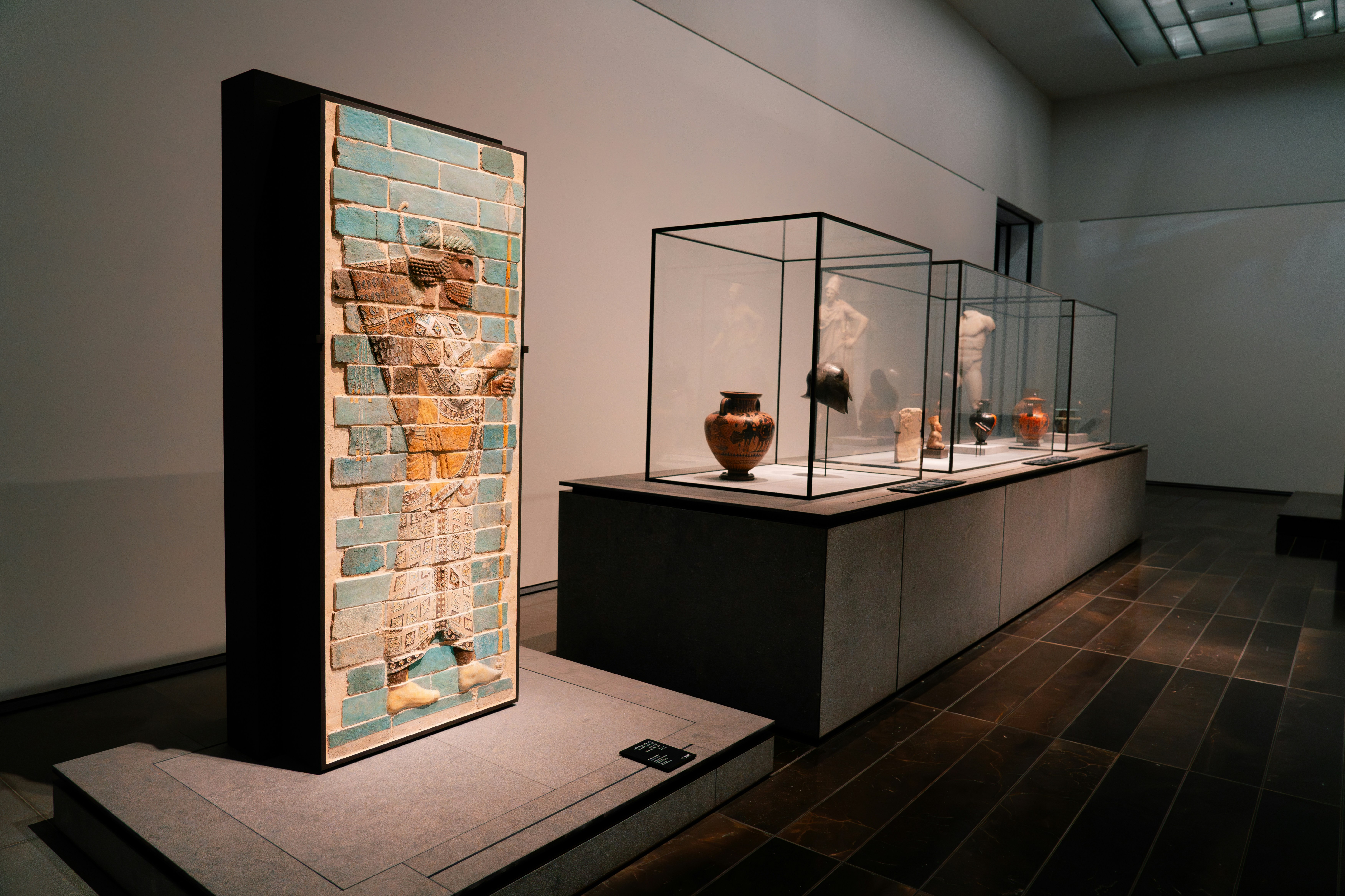 A room filled with glass cases filled with vases
