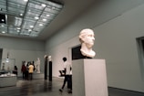 A group of people walking around a museum