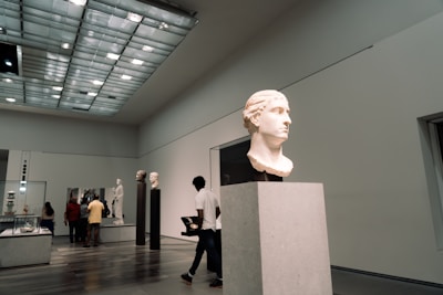 A group of people walking around a museum