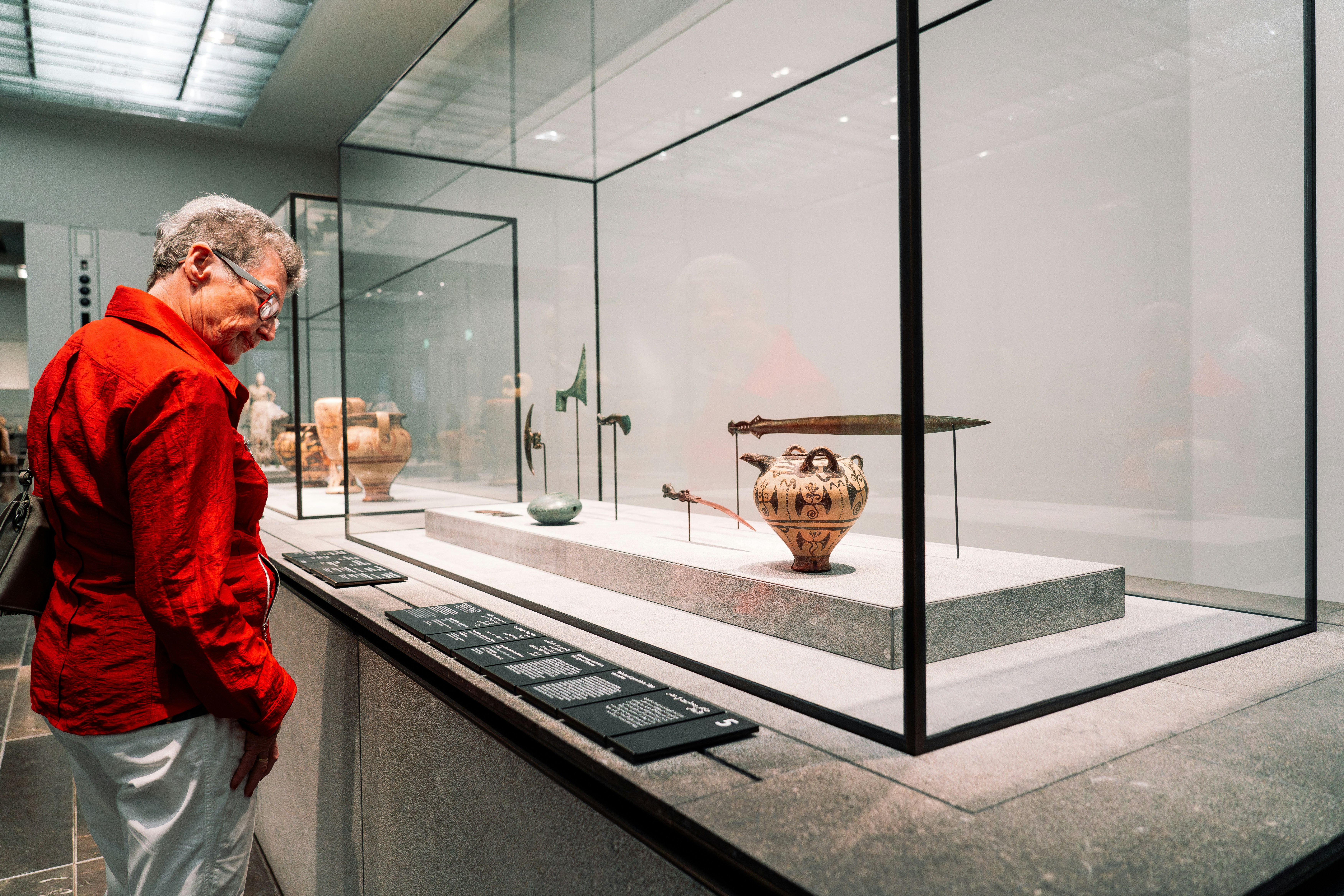 A man looking at a display case in a museum
