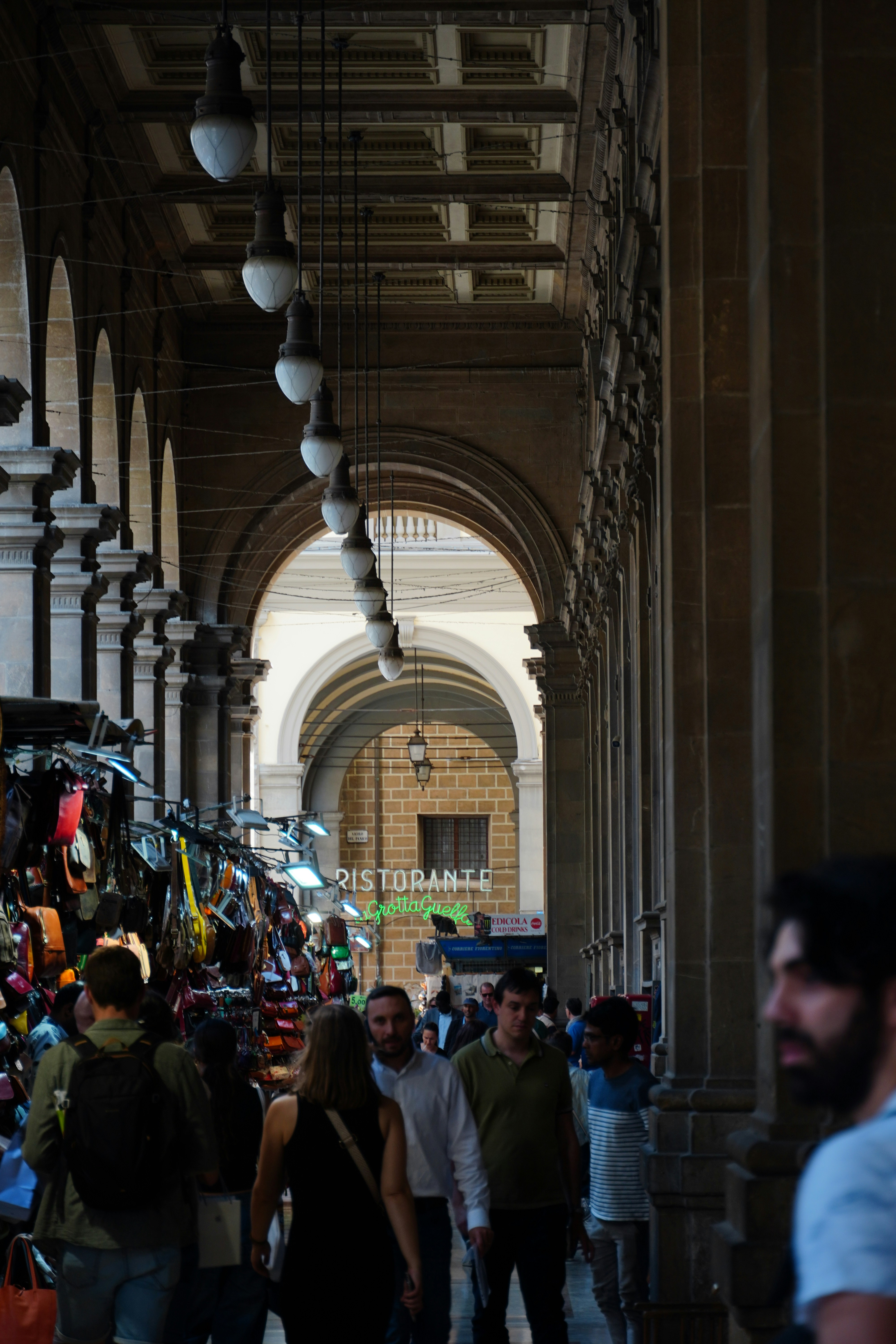A group of people walking through a large building