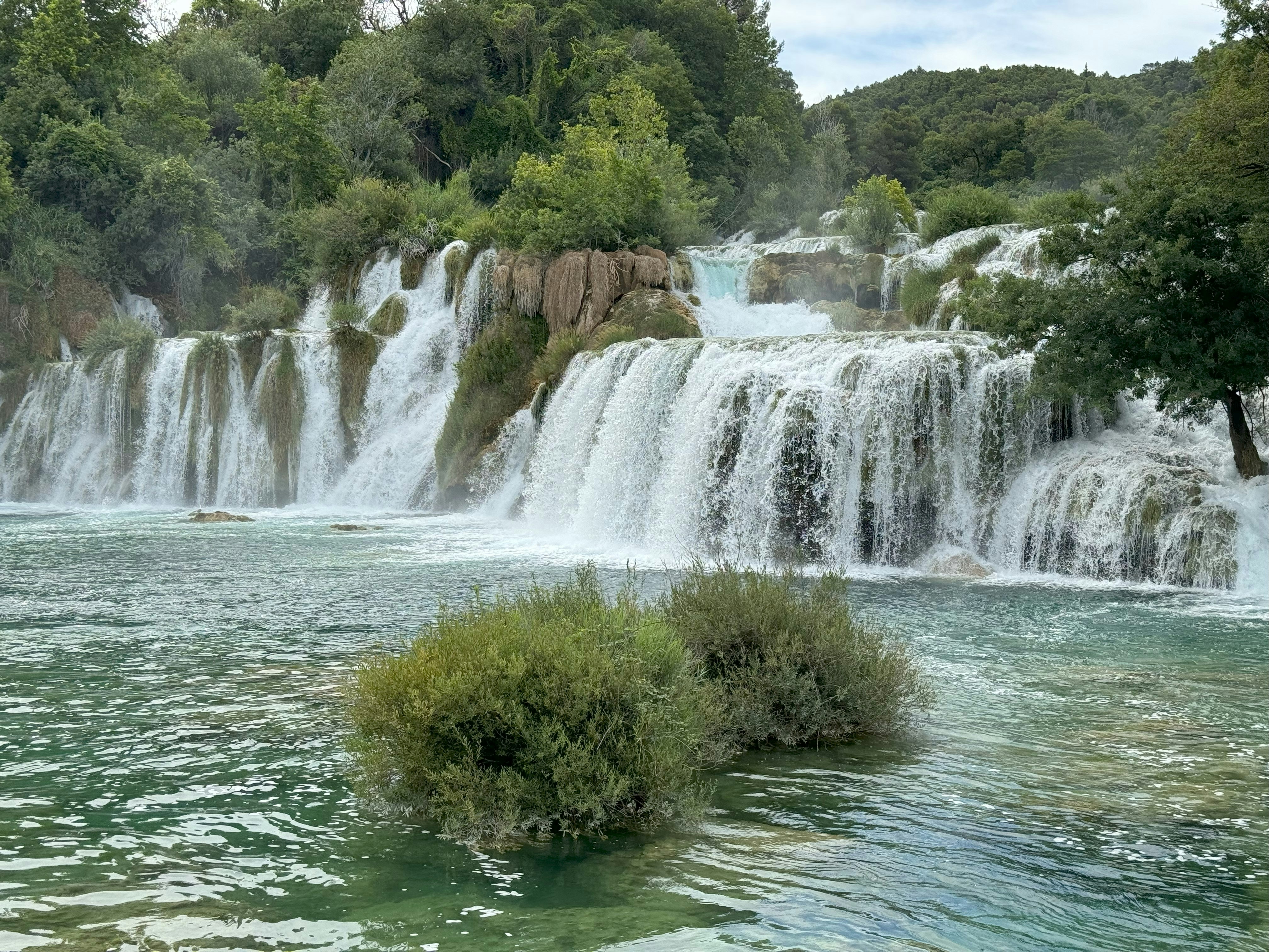 A large waterfall with lots of water coming out of it