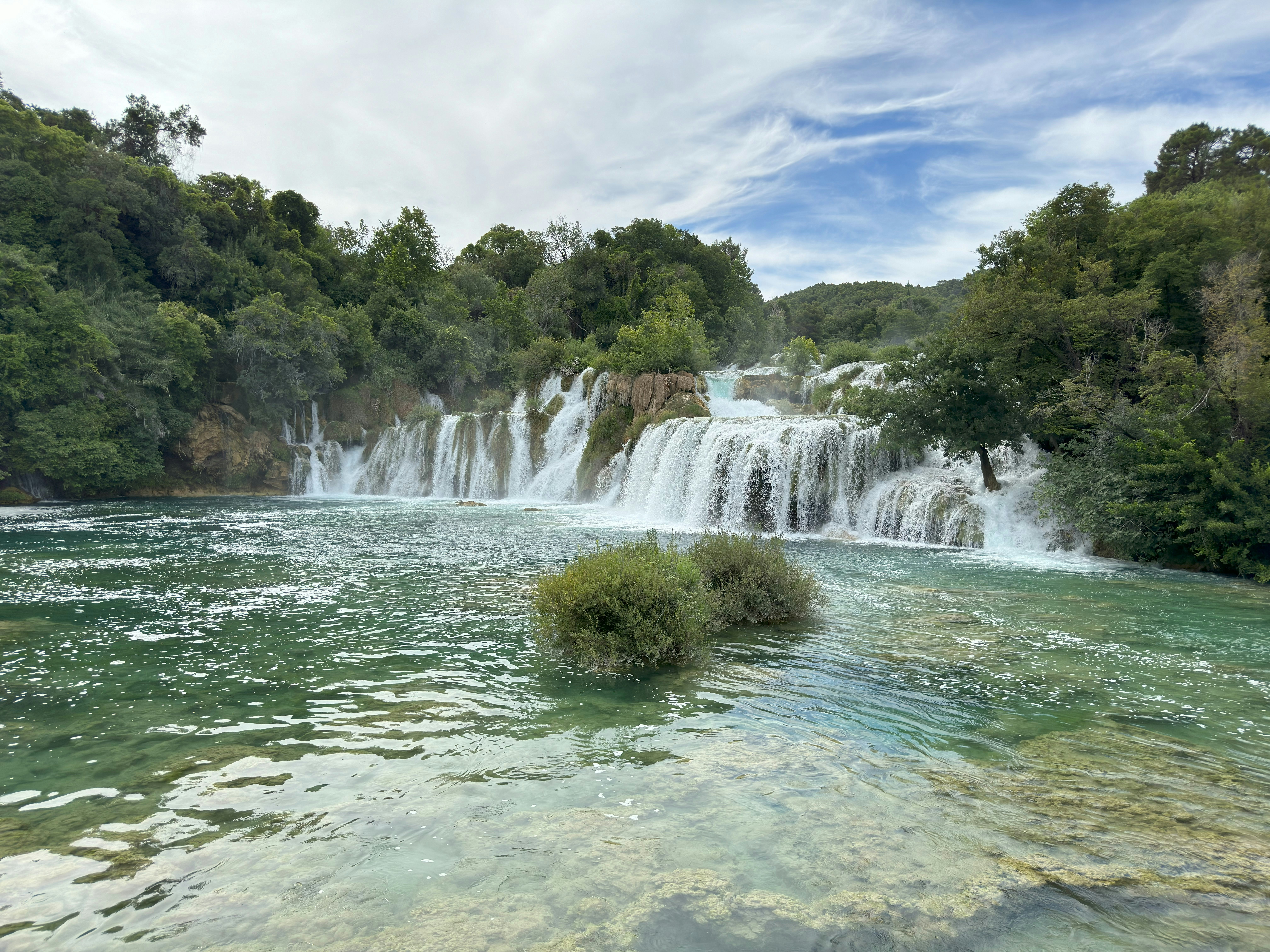 A large waterfall in the middle of a body of water