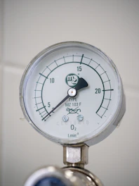 A close up of a pressure gauge on a wall