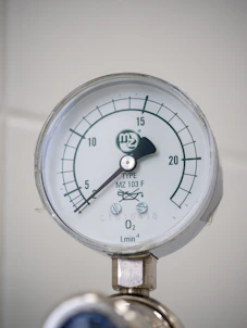 A close up of a pressure gauge on a wall