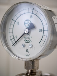 A close up of a pressure gauge on a pipe