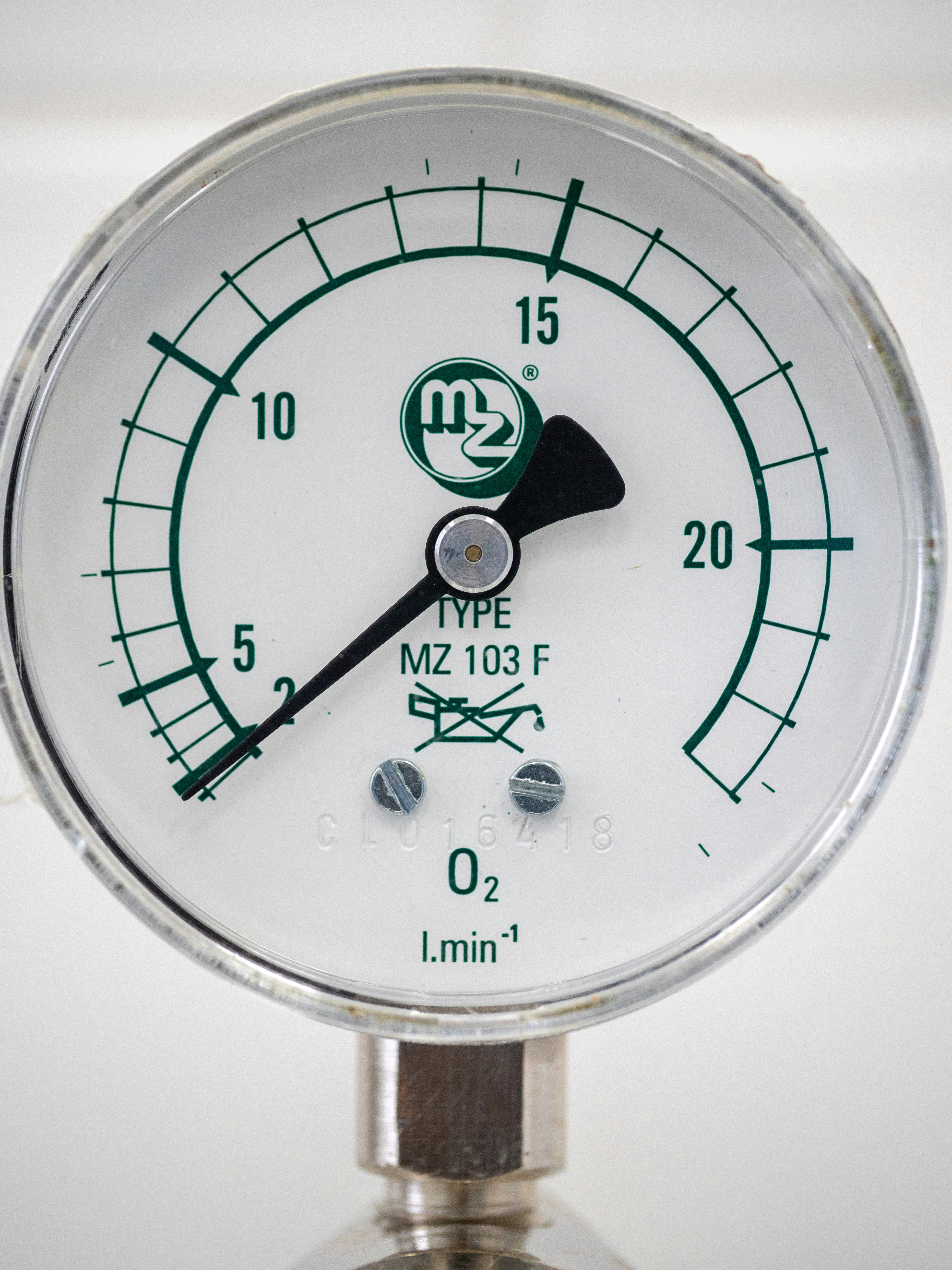 A close up of a pressure gauge on a white surface