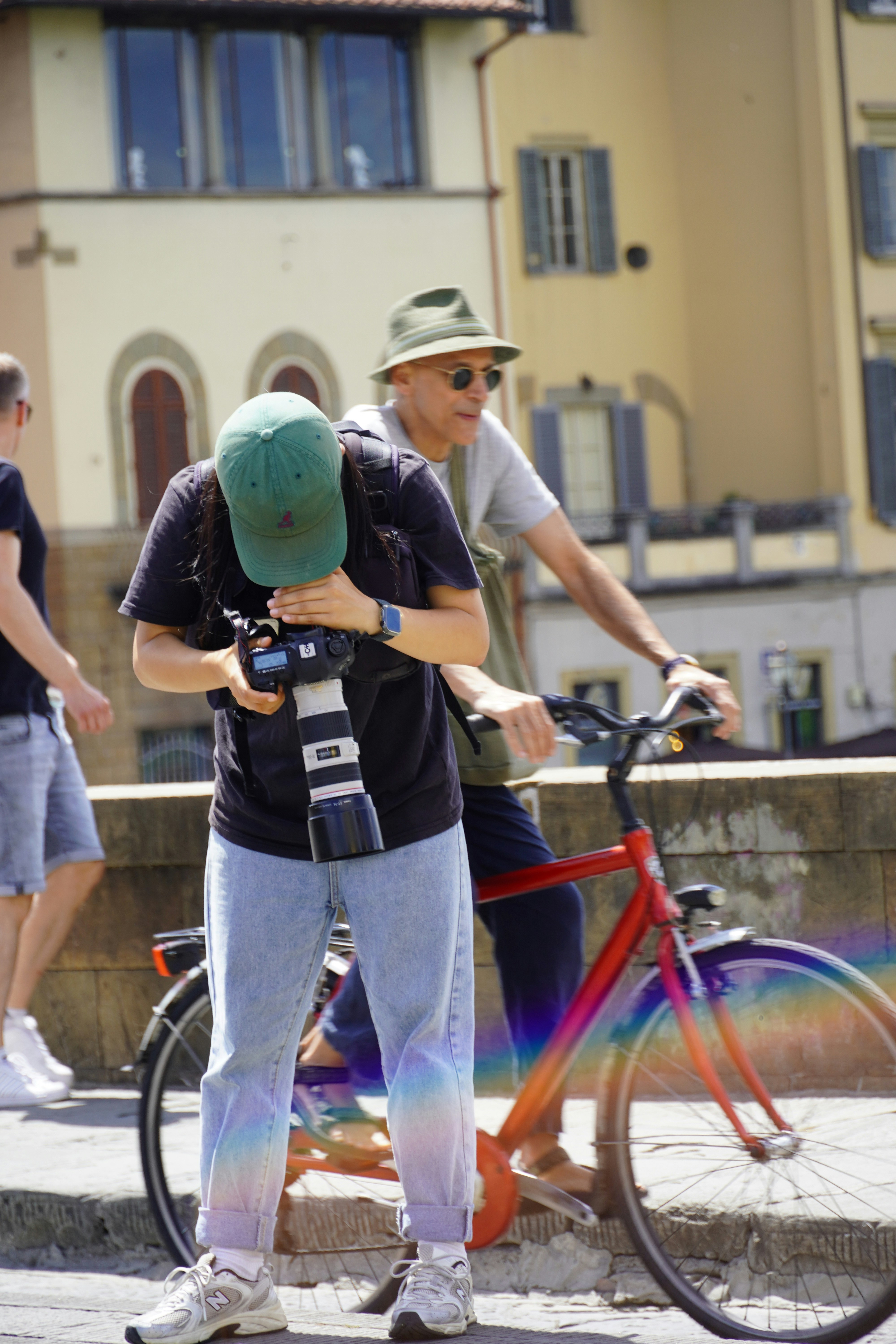 A man standing next to a red bike