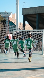A group of young boys playing a game of soccer