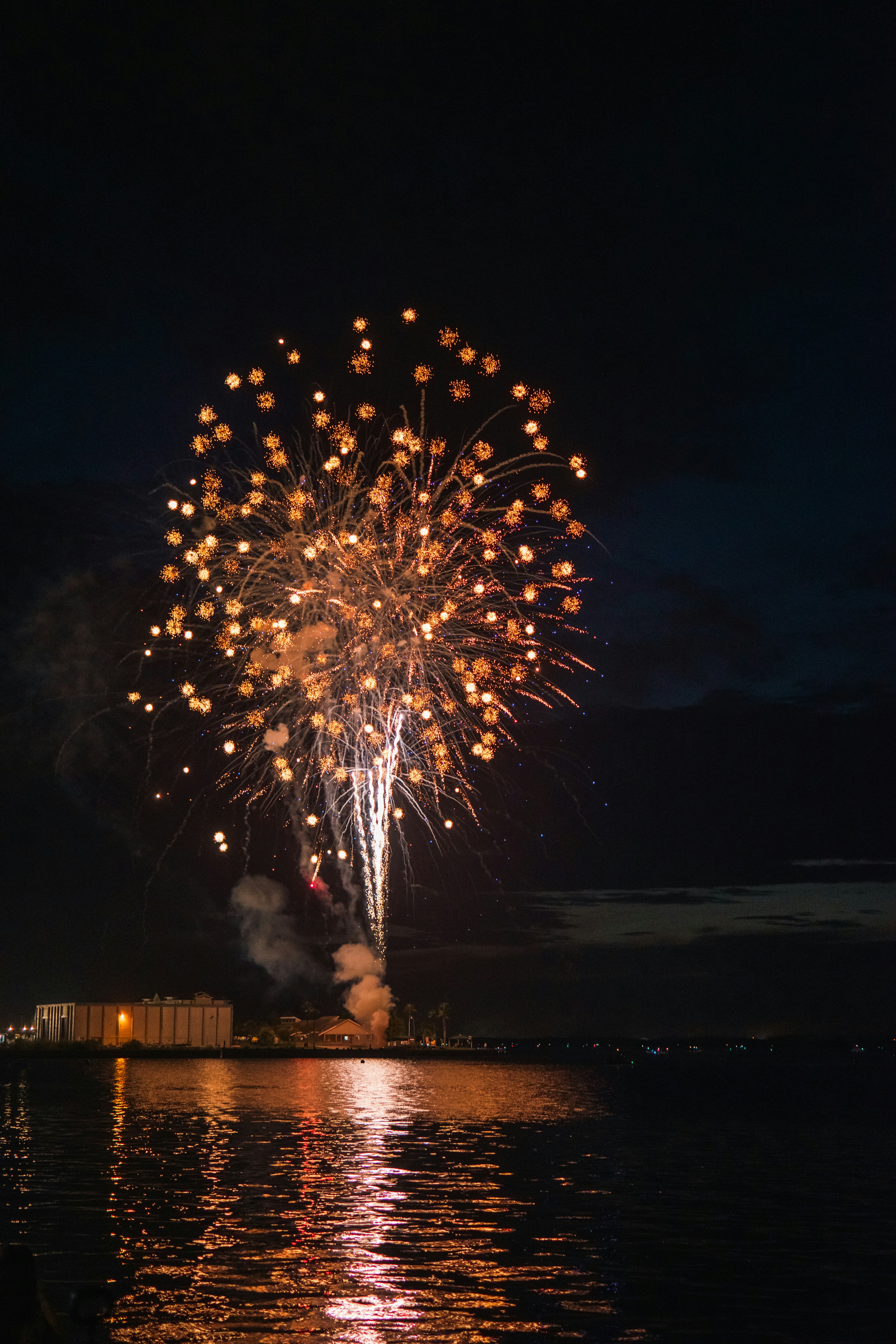 A large fireworks is lit up in the night sky
