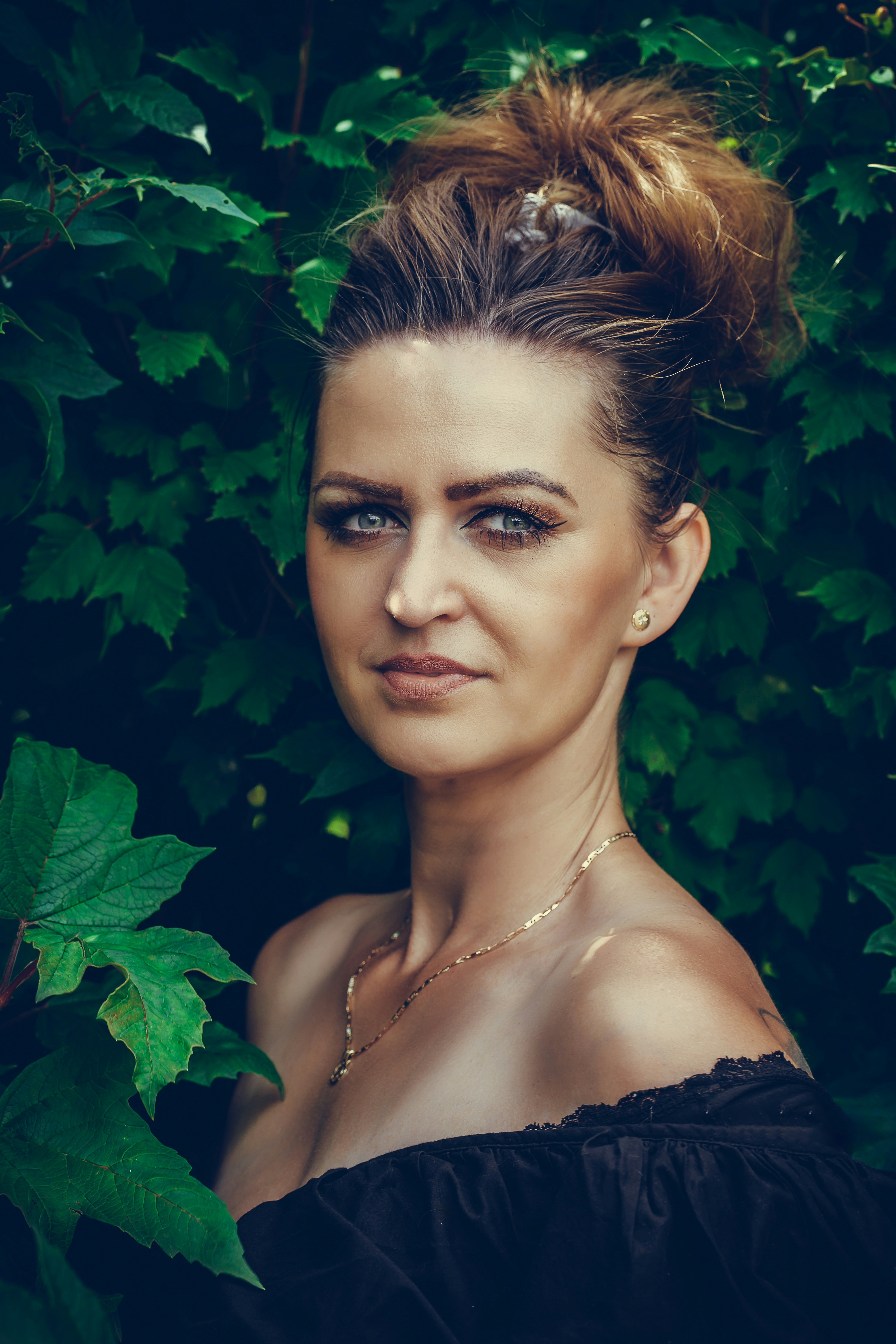 A woman standing in front of a bush